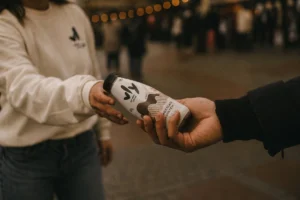 Promotional staff handing out product at a brand activation, run with Liveforce promotional staffing software